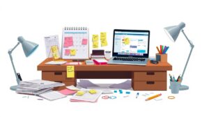 Een rommelig bureau met een open laptop, kalender en notities.